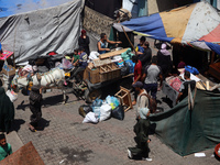 Palestinians are fleeing with their belongings in Deir el-Balah, in the central Gaza Strip, on August 16, 2024, amid the ongoing conflict be...