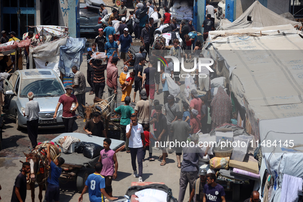 Palestinians are fleeing with their belongings in Deir el-Balah, in the central Gaza Strip, on August 16, 2024, amid the ongoing conflict be...