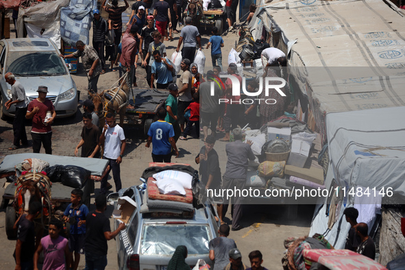 Palestinians are fleeing with their belongings in Deir el-Balah, in the central Gaza Strip, on August 16, 2024, amid the ongoing conflict be...