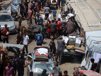 Palestinians are fleeing with their belongings in Deir el-Balah, in the central Gaza Strip, on August 16, 2024, amid the ongoing conflict be...