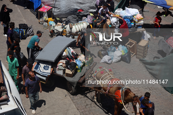 Palestinians are fleeing with their belongings in Deir el-Balah, in the central Gaza Strip, on August 16, 2024, amid the ongoing conflict be...