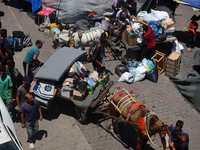 Palestinians are fleeing with their belongings in Deir el-Balah, in the central Gaza Strip, on August 16, 2024, amid the ongoing conflict be...