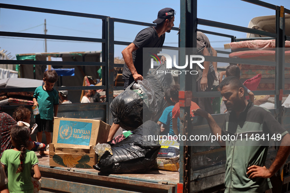 Palestinians are fleeing with their belongings in Deir el-Balah, in the central Gaza Strip, on August 16, 2024, amid the ongoing conflict be...