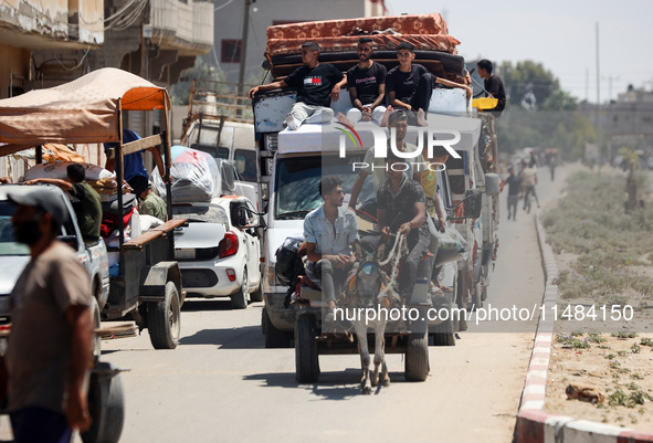 Palestinians are fleeing with their belongings in Deir el-Balah, in the central Gaza Strip, on August 16, 2024, amid the ongoing conflict be...