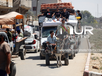 Palestinians are fleeing with their belongings in Deir el-Balah, in the central Gaza Strip, on August 16, 2024, amid the ongoing conflict be...