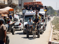 Palestinians are fleeing with their belongings in Deir el-Balah, in the central Gaza Strip, on August 16, 2024, amid the ongoing conflict be...