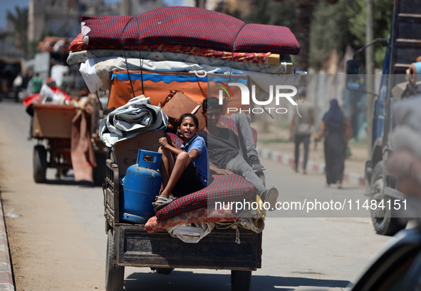 Palestinians are fleeing with their belongings in Deir el-Balah, in the central Gaza Strip, on August 16, 2024, amid the ongoing conflict be...