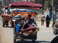 Palestinians are fleeing with their belongings in Deir el-Balah, in the central Gaza Strip, on August 16, 2024, amid the ongoing conflict be...