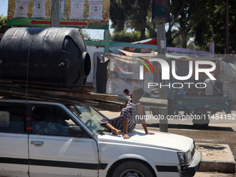 Palestinians are fleeing with their belongings in Deir el-Balah, in the central Gaza Strip, on August 16, 2024, amid the ongoing conflict be...