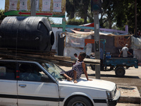 Palestinians are fleeing with their belongings in Deir el-Balah, in the central Gaza Strip, on August 16, 2024, amid the ongoing conflict be...