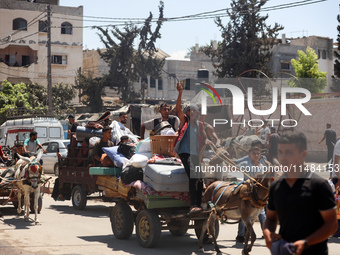 Palestinians are fleeing with their belongings in Deir el-Balah, in the central Gaza Strip, on August 16, 2024, amid the ongoing conflict be...