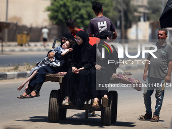 Palestinians are fleeing with their belongings in Deir el-Balah, in the central Gaza Strip, on August 16, 2024, amid the ongoing conflict be...