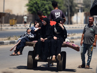 Palestinians are fleeing with their belongings in Deir el-Balah, in the central Gaza Strip, on August 16, 2024, amid the ongoing conflict be...