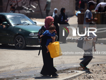 Palestinians are fleeing with their belongings in Deir el-Balah, in the central Gaza Strip, on August 16, 2024, amid the ongoing conflict be...