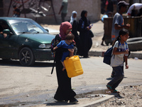 Palestinians are fleeing with their belongings in Deir el-Balah, in the central Gaza Strip, on August 16, 2024, amid the ongoing conflict be...