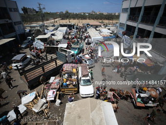 Palestinians are fleeing with their belongings in Deir el-Balah, in the central Gaza Strip, on August 16, 2024, amid the ongoing conflict be...