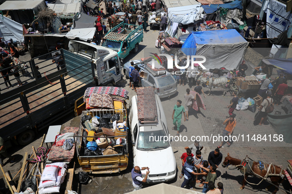 Palestinians are fleeing with their belongings in Deir el-Balah, in the central Gaza Strip, on August 16, 2024, amid the ongoing conflict be...