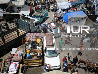 Palestinians are fleeing with their belongings in Deir el-Balah, in the central Gaza Strip, on August 16, 2024, amid the ongoing conflict be...