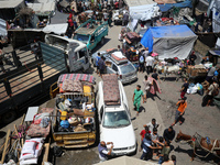 Palestinians are fleeing with their belongings in Deir el-Balah, in the central Gaza Strip, on August 16, 2024, amid the ongoing conflict be...