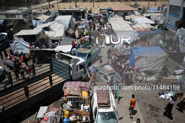 Palestinians are fleeing with their belongings in Deir el-Balah, in the central Gaza Strip, on August 16, 2024, amid the ongoing conflict be...