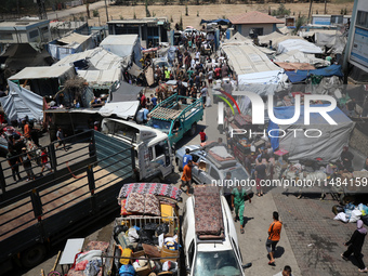 Palestinians are fleeing with their belongings in Deir el-Balah, in the central Gaza Strip, on August 16, 2024, amid the ongoing conflict be...