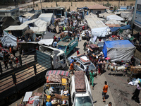 Palestinians are fleeing with their belongings in Deir el-Balah, in the central Gaza Strip, on August 16, 2024, amid the ongoing conflict be...