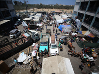 Palestinians are fleeing with their belongings in Deir el-Balah, in the central Gaza Strip, on August 16, 2024, amid the ongoing conflict be...