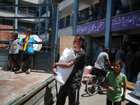 Palestinians are fleeing with their belongings in Deir el-Balah, in the central Gaza Strip, on August 16, 2024, amid the ongoing conflict be...