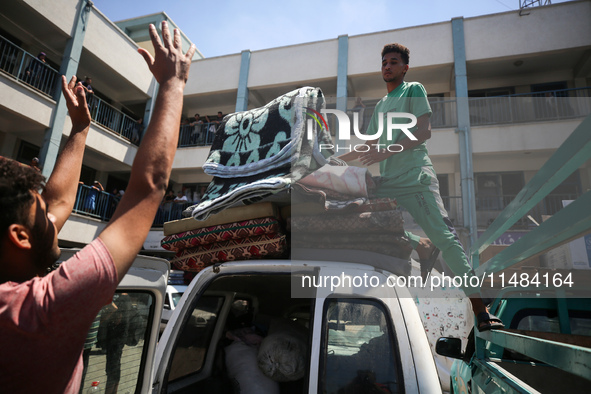 Palestinians are fleeing with their belongings in Deir el-Balah, in the central Gaza Strip, on August 16, 2024, amid the ongoing conflict be...