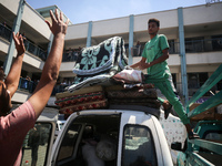 Palestinians are fleeing with their belongings in Deir el-Balah, in the central Gaza Strip, on August 16, 2024, amid the ongoing conflict be...