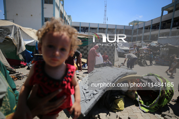 Palestinians are fleeing with their belongings in Deir el-Balah, in the central Gaza Strip, on August 16, 2024, amid the ongoing conflict be...