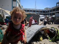 Palestinians are fleeing with their belongings in Deir el-Balah, in the central Gaza Strip, on August 16, 2024, amid the ongoing conflict be...