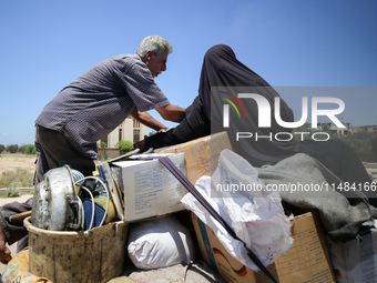 Palestinians are fleeing with their belongings in Deir el-Balah, in the central Gaza Strip, on August 16, 2024, amid the ongoing conflict be...