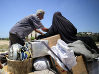 Palestinians are fleeing with their belongings in Deir el-Balah, in the central Gaza Strip, on August 16, 2024, amid the ongoing conflict be...