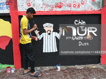 Students are painting graffiti on a wall alongside a road to express their message after the fall of Bangladesh's former Prime Minister Shei...