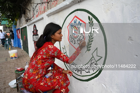 Students are painting graffiti on a wall alongside a road to express their message after the fall of Bangladesh's former Prime Minister Shei...