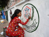 Students are painting graffiti on a wall alongside a road to express their message after the fall of Bangladesh's former Prime Minister Shei...