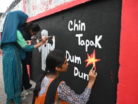 Students are painting graffiti on a wall alongside a road to express their message after the fall of Bangladesh's former Prime Minister Shei...