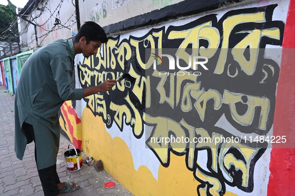 Students are painting graffiti on a wall alongside a road to express their message after the fall of Bangladesh's former Prime Minister Shei...