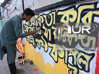 Students are painting graffiti on a wall alongside a road to express their message after the fall of Bangladesh's former Prime Minister Shei...