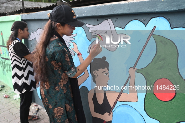 Students are painting graffiti on a wall alongside a road to express their message after the fall of Bangladesh's former Prime Minister Shei...