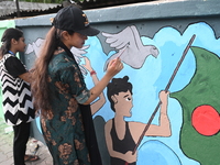 Students are painting graffiti on a wall alongside a road to express their message after the fall of Bangladesh's former Prime Minister Shei...