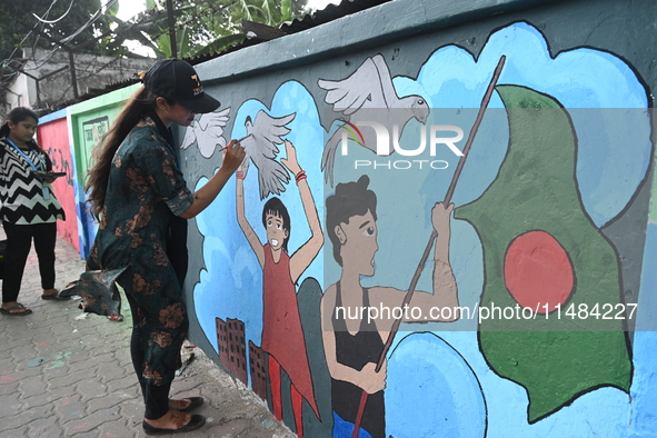 Students are painting graffiti on a wall alongside a road to express their message after the fall of Bangladesh's former Prime Minister Shei...