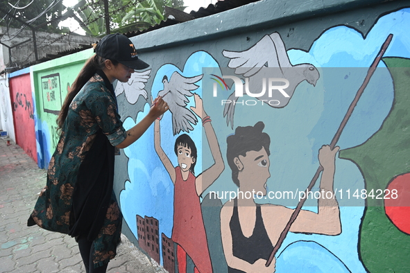 Students are painting graffiti on a wall alongside a road to express their message after the fall of Bangladesh's former Prime Minister Shei...