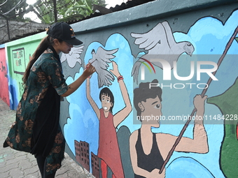 Students are painting graffiti on a wall alongside a road to express their message after the fall of Bangladesh's former Prime Minister Shei...