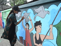 Students are painting graffiti on a wall alongside a road to express their message after the fall of Bangladesh's former Prime Minister Shei...