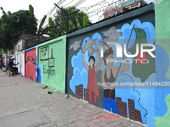 Students are painting graffiti on a wall alongside a road to express their message after the fall of Bangladesh's former Prime Minister Shei...