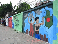 Students are painting graffiti on a wall alongside a road to express their message after the fall of Bangladesh's former Prime Minister Shei...