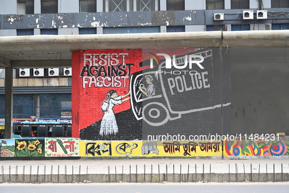 Students are painting graffiti on a wall alongside a road to express their message after the fall of Bangladesh's former Prime Minister Shei...