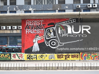 Students are painting graffiti on a wall alongside a road to express their message after the fall of Bangladesh's former Prime Minister Shei...